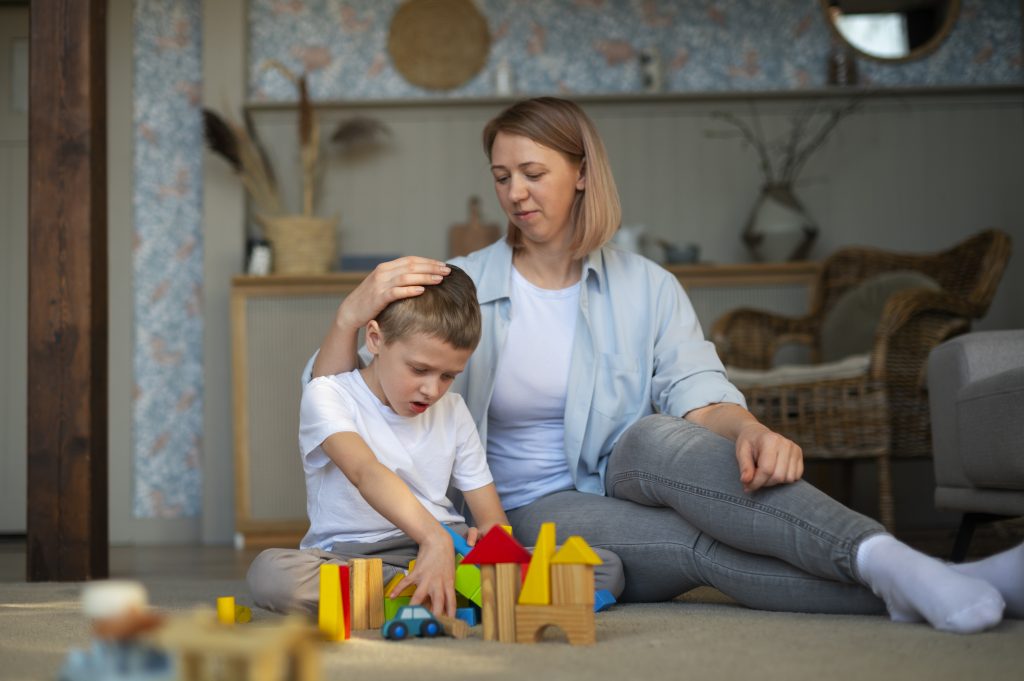 mother playing with her autistic son using toys